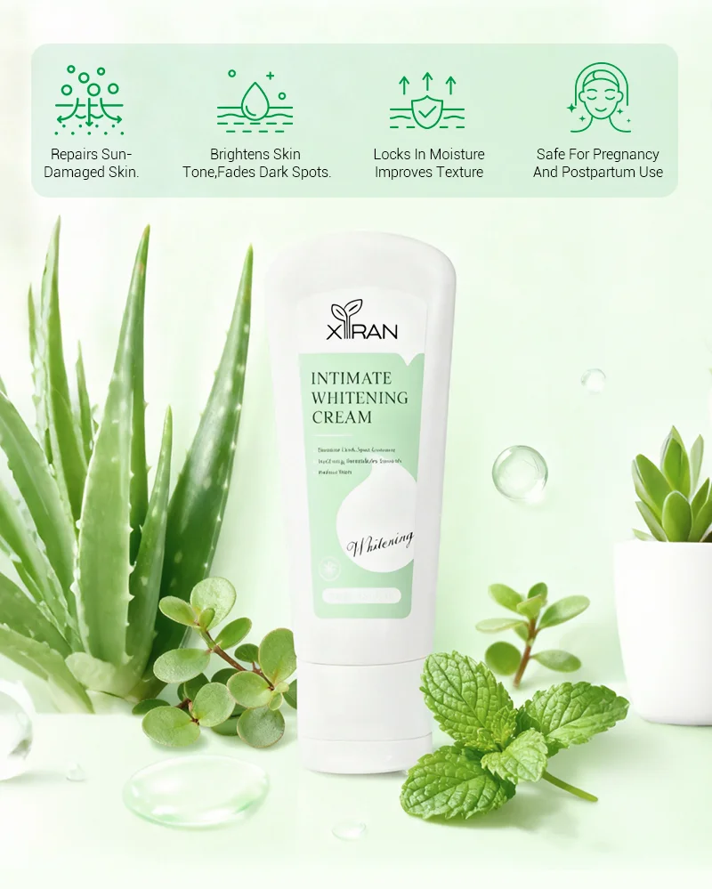 XIRAN Intimate Whitening Cream tube surrounded by aloe vera and mint leaves on a green background showcasing product benefits.